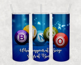 May include: Three blue stainless steel tumblers with a white and blue starry background. The tumblers feature colourful bingo balls with the letters B, I, N, G, and O. The text "What happens at Bingo stays at Bingo" is printed on the tumblers.