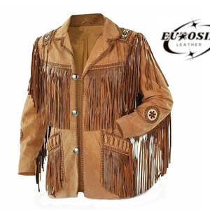 May include: A tan suede jacket with long fringe detailing on the sleeves, chest, and pockets. The jacket has decorative stitching and silver buttons. The brand name "EUROSIAL LEATHER" is printed on the upper right corner.