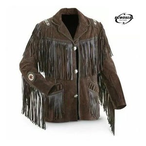 May include: Brown suede jacket with fringe detailing. The jacket features a notched collar, silver buttons, and decorative beading on the shoulders and sleeves. The jacket has two front pockets and the brand logo "EUROSIAI LEATHER" in the upper right corner.
