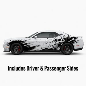 May include: White car with black skull and splatter design decals. The decals include a skull with horns and crossbones. The text "Includes Driver & Passenger Sides" is at the bottom.