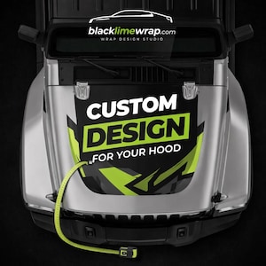 May include: Overhead shot of a silver vehicle bonnet with a custom design wrap. The wrap displays the text "CUSTOM DESIGN FOR YOUR HOOD" in white and green. A yellow measuring tape is draped across the bonnet.