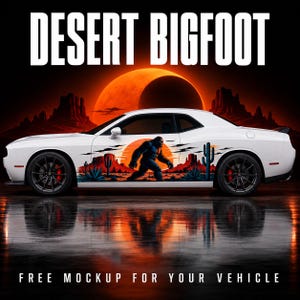 May include: A white two-door coupe vehicle featuring a graphic decal on the side panel. The decal depicts a dark silhouette of a Bigfoot creature walking through a desert landscape with cacti and a large orange sun. Text reads DESERT BIGFOOT.