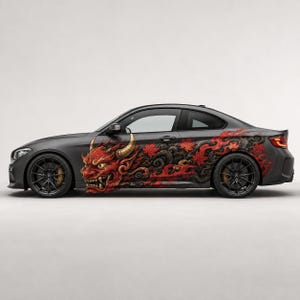 May include: A matte gray coupe car featuring a large, detailed red Japanese demon mask graphic on the side panel. The design incorporates swirling dark smoke patterns and vibrant red maple leaves that extend toward the rear of the vehicle.
