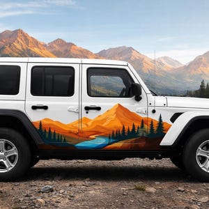May include: A white four-door SUV featuring a large side decal of a mountain landscape. The graphic displays orange and yellow peaks, a blue river, and dark green pine trees along the lower body panels, contrasting with the vehicle's white paint.