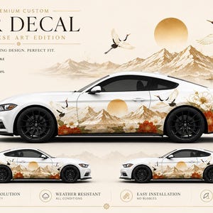 May include: White car decal with a Japanese art design featuring a mountain landscape, cranes, and flowers. The decal includes the text "Premium Custom Car Decal Japanese Art Edition". The design is on both sides of the car.