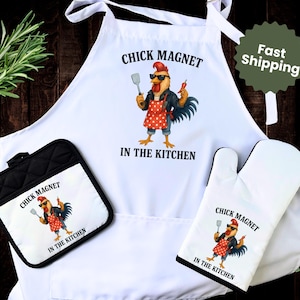 May include: A white apron, oven mitt, and pot holder set. Each item features a cartoon rooster wearing sunglasses, a red polka-dot apron, and the text "CHICK MAGNET IN THE KITCHEN". The set is designed for cooking.