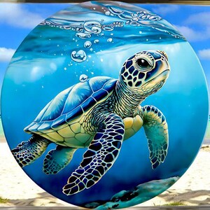 May include: A green sea turtle swims in blue water with bubbles around it. The turtle has a detailed shell with black and yellow markings. The background is a blue ocean with a white sandy beach.