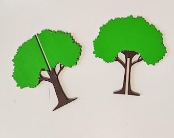 May include: Two flat, tree-shaped cutouts featuring a vibrant green canopy and a dark brown trunk. Each tree has a vertical slit running from the top of the canopy down through the center of the trunk, allowing the two pieces to interlock.