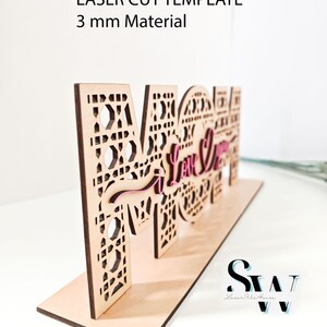 May include: A laser cut wooden sign spelling MOM with intricate geometric patterns and the script text I Love You in pink. The sign is designed for 3 mm material and includes file formats SVG, CDR, AI, DXF, EPS, PDF, PNG, and Lightburn.