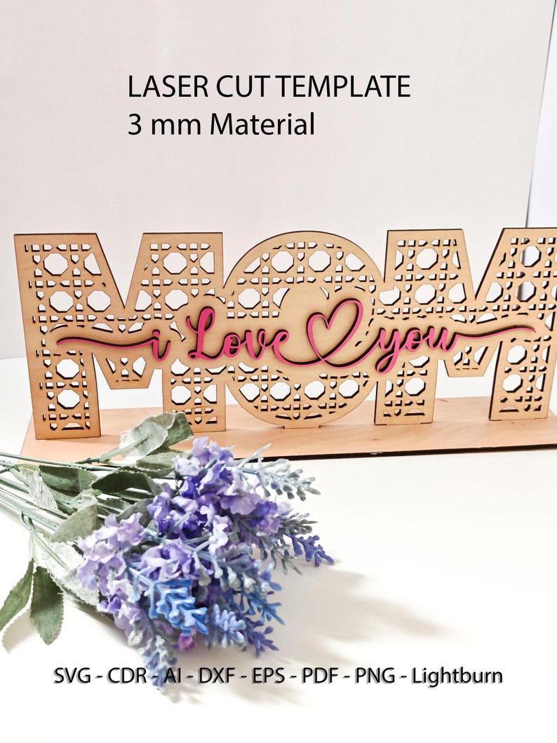 May include: A laser cut wooden sign featuring the word MOM with a cane webbing pattern, layered with a pink script text reading I Love You. The sign is designed for 3 mm material and includes file formats SVG, CDR, AI, DXF, EPS, PDF, PNG, and Lightburn.