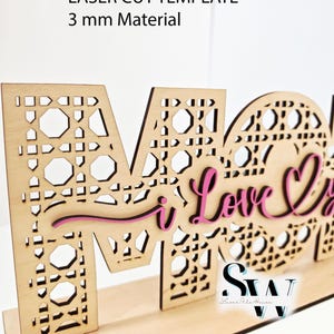 May include: A laser-cut wooden sign featuring the word MOM with a cane webbing pattern. The text I Love You is layered in pink script over the letters. The sign includes the text LASER CUT TEMPLATE 3 mm Material and SVG CDR AI DXF EPS PDF PNG Lightburn.