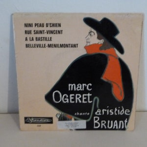 May include: A vintage record album cover featuring a black and white illustration of a man wearing a black hat and coat. The text on the cover reads "NINI PEAU D'CHIEN RUE SAINT-VINCENT A LA BASTILLE BELLEVILLE-MENILMONTANT marc OGERET chante aristide BRUANT".