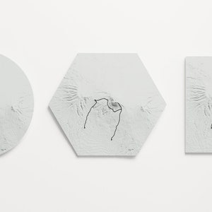 Three outline variations hang on wall next to each other for comparison. Circle on the left, hexagon in the center, square on the right. All are grey with black trail.