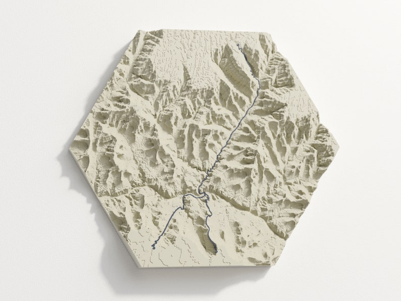 Hexagon outline, beige colour variant hangs on wall, the trail is dark blue grey.