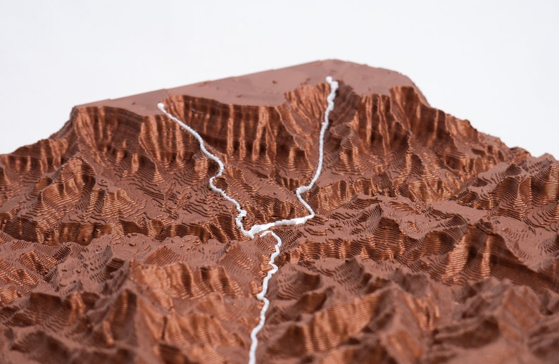 Closeup detail shot of trail showcasing copper material and 3D printed layers. Topographic detail can be seen clearly.