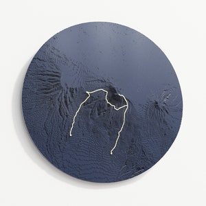 Circle outline, graphite blue colour variant hangs on wall, the trail is almond yellow.