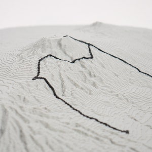 Closeup detail shot trail section showcasing matte grey material and 3D printed layers. Topographic detail can be seen clearly.