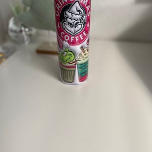 Pink Christmas Grinch 20 oz tumbler with lid, stainless steel straw, rubber bottom and holiday straw charm