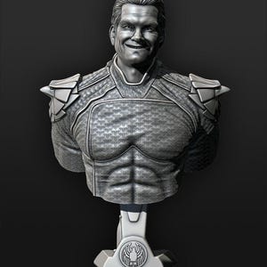 May include: A gray bust sculpture of a smiling man with short hair, wearing a detailed textured suit with geometric shoulder pads. The base features a stylized emblem. The sculpture is set against a dark background.
