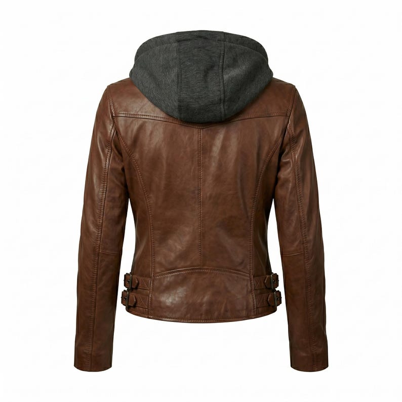 May include: Brown leather jacket with a gray hooded sweatshirt insert. The jacket has a classic design with a zipper closure and two decorative buckles at the waist. The back view shows the stitching details and the texture of the leather.