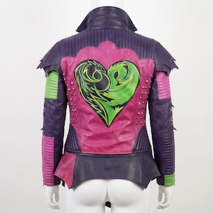 May include: A purple and pink leather jacket featuring a large green heart graphic on the back. The jacket includes silver metal studs, quilted shoulder and sleeve panels, a high collar, and layered shoulder detailing with bright green accents.