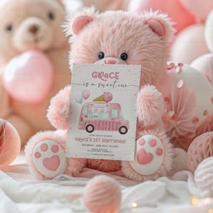 May include: Pink teddy bear holding a pink and white ice cream truck birthday invitation card that says "GRACE is a sweet one" and "GRACE'S 1ST BIRTHDAY!" with pink and white polka dots in the background.