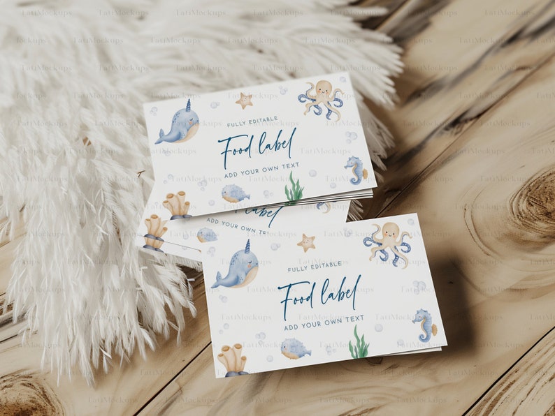 May include: A stack of white food labels with an ocean theme. Each label features watercolor illustrations of sea creatures like narwhals, octopuses, and seahorses. The text "Food label" and "Add your own text" are visible.