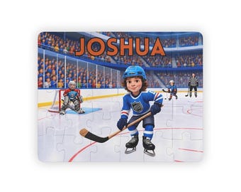May include: A rectangular jigsaw puzzle featuring a cartoon hockey scene on an ice rink. The name JOSHUA is printed in large orange letters at the top. A central hockey player in a blue uniform holds a stick, with a goalie and referee visible.