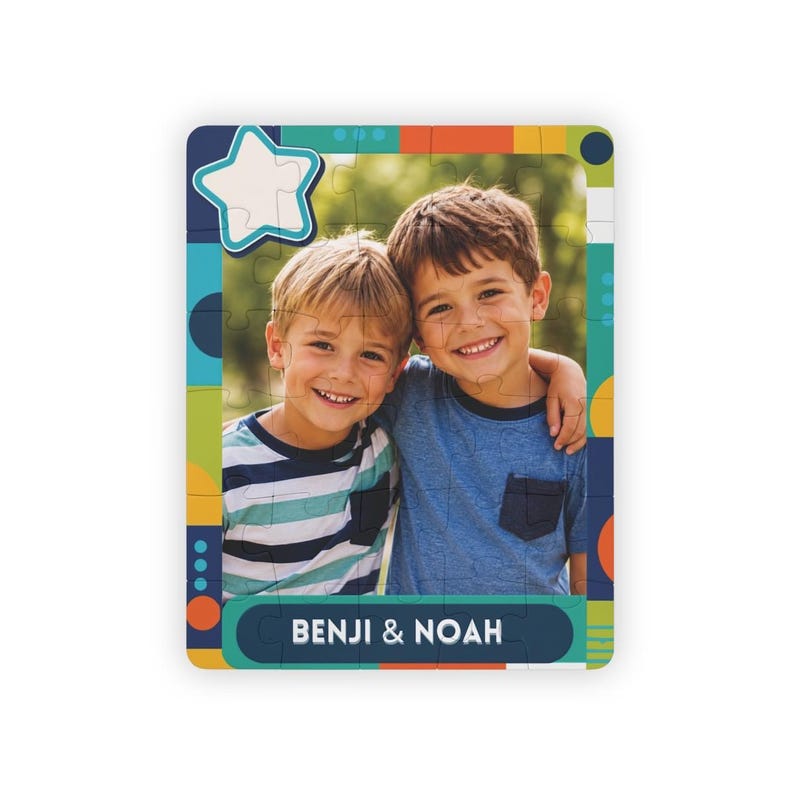 May include: A rectangular jigsaw puzzle featuring a photograph of two smiling children. The border has a colorful geometric pattern with circles and stripes. A white star shape is in the top left corner, and the text BENJI & NOAH is at the bottom.