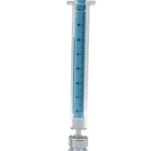 May include: A blue and clear syringe with a blue plunger and measurement markings, connected to a small glass vial containing blue liquid. The vial has a white label with a blue cross symbol.