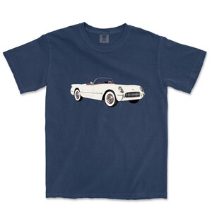 May include: Navy blue t-shirt featuring a white convertible car with red interior and white-walled tires. The classic car graphic is centered on the front of the shirt. The t-shirt is made of a soft, comfortable material.