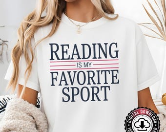 May include: White t-shirt with the text "READING IS MY FAVORITE SPORT" in navy blue and red. The shirt has a round neckline and short sleeves. A digital download badge is visible in the lower right corner.