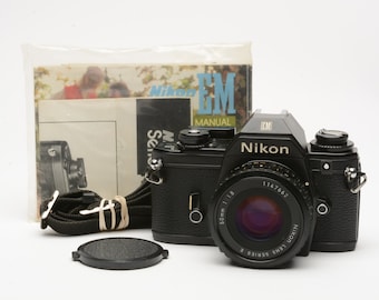 Nikon EM 35mm SLR w/Nikon Series E 50mm f1.8 lens, strap, cap, manual, new seals