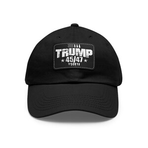 May include: Black baseball cap with a white patch that says "TRUMP 45/47" with a small American flag graphic above the text.