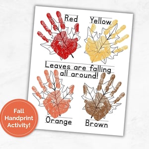 May include: A white paper with four handprint leaf designs in red, yellow, orange, and brown, labeled with the corresponding colors. The text "Leaves are falling all around!" is written across the center. A circular orange sticker reads "Fall Handprint Activity!"