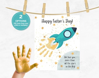 May include: A Father's Day card with a teal rocket ship illustration and a handprint trail. The card reads "Happy Father's Day!" and "We love you more than all the stars in the sky!" A hand is painted gold. The card is held by clothespins.