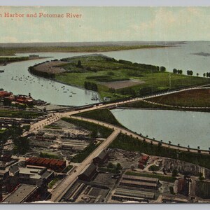May include: Vintage postcard featuring an aerial view of Washington Harbor and the Potomac River. The image shows a bridge, buildings, and a large body of water with boats. The sky is a pale blue, and the land is green.