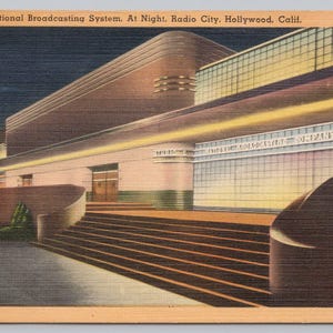 May include: Vintage postcard depicting the Studio of National Broadcasting System at night in Radio City, Hollywood, California. The art deco building features a stepped facade, illuminated signage, and a dark blue night sky. The NBC logo is visible.