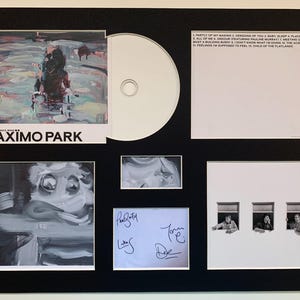 May include: Framed Maximo Park album art and memorabilia. The album cover features abstract art with the band's name. Includes a CD, a signed note, and other artwork. The album title is "Nature Always Wins".