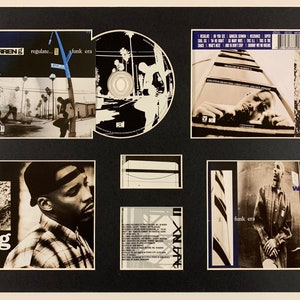 May include: A framed display of Warren G's "Regulate... G Funk Era" album, including the CD and associated artwork. The images feature the artist, street scenes, and album information. The display is set against a black background.