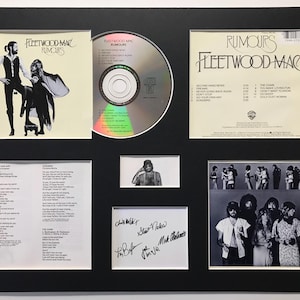 May include: Framed display of Fleetwood Mac's "Rumours" album, featuring the album cover, CD, lyrics, and band photos. Presented in a black frame with white mount, highlighting the album's artwork and memorabilia.