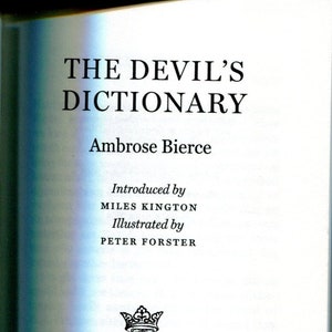 May include: The Devil's Dictionary by Ambrose Bierce, a book cover with black text on a white background. The book was introduced by Miles Kington and illustrated by Peter Forster. The Folio Society published the book in 2003.