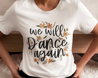 Könnte beinhalten: Weißes T-Shirt mit floralem Design und dem Text "We will dance again".