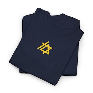 May include: Two navy blue t-shirts are neatly folded, showcasing a yellow geometric star design on the front. The shirts are made of a soft material, perfect for casual wear. The design is simple and modern.