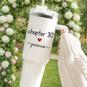 May include: White insulated tumbler with a handle, a black lid, and a clear straw. The tumbler has the text "chapter 30" above a red heart and the name "jessica" in black script.