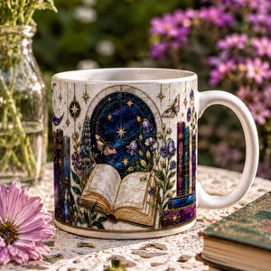 A white ceramic mug with a detailed illustration of a book, flowers, and a starry night sky, placed on a lace tablecloth.