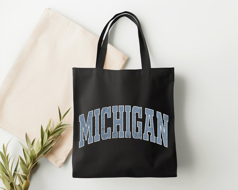 May include: Black canvas tote bag with a blue and white vintage-style "MICHIGAN" graphic.