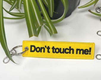 consent warning yellow and black bag charm neurodivergent keychains