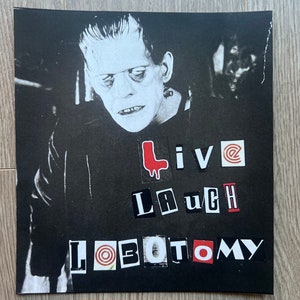 May include: Black and white image of Frankenstein's monster with the words "Live Laugh Lobotomy" in red and white letters.