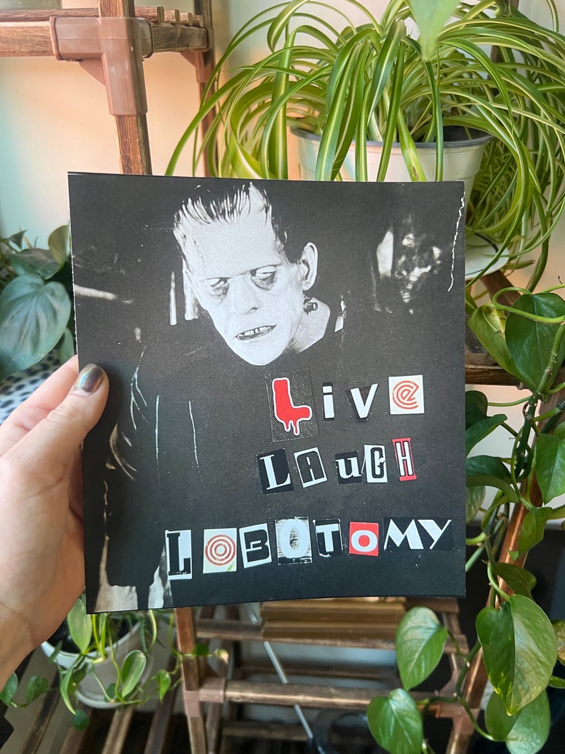 May include: Black and white image of Frankenstein's monster with the words "Live Laugh Lobotomy" in red and black letters.